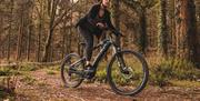 Woman riding a bike in the forest