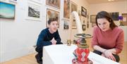 Couple looking at a sculpture in the exhibition