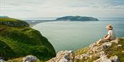 Man sat on top of Little Orme looking over to the Great Orme