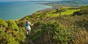 Lady walking on the Little Orme towards Penrhyn Bay