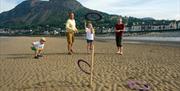 Family playing quoits on Llanfairfechan Beach