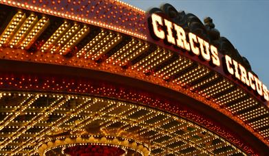 Circus roof sign surrounded by yellow and red lights