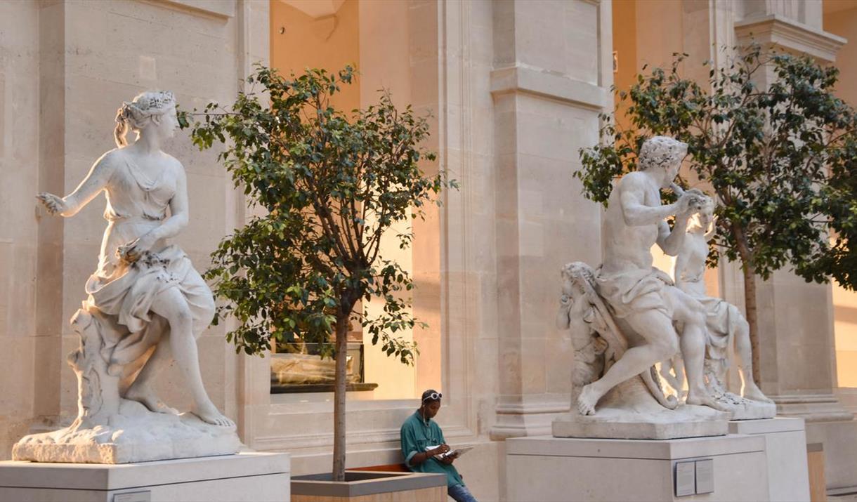 White marble statues outside museum White marble statues outside museum