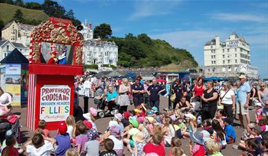 Children and families watching the Punch and Judy show in Llandudno