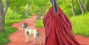 Picture of Lady in Tudor dress walking through forest with a dog