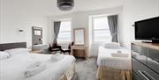 Double bed and single bed with two windows in a sea view  family room