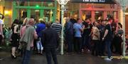 Crowds outside Irish Bar in the evening