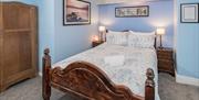 Double bedroom decorated with a blue theme at Bryn Woodlands Guest House