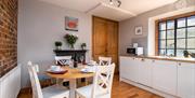 Kitchen with round dining table seating four people