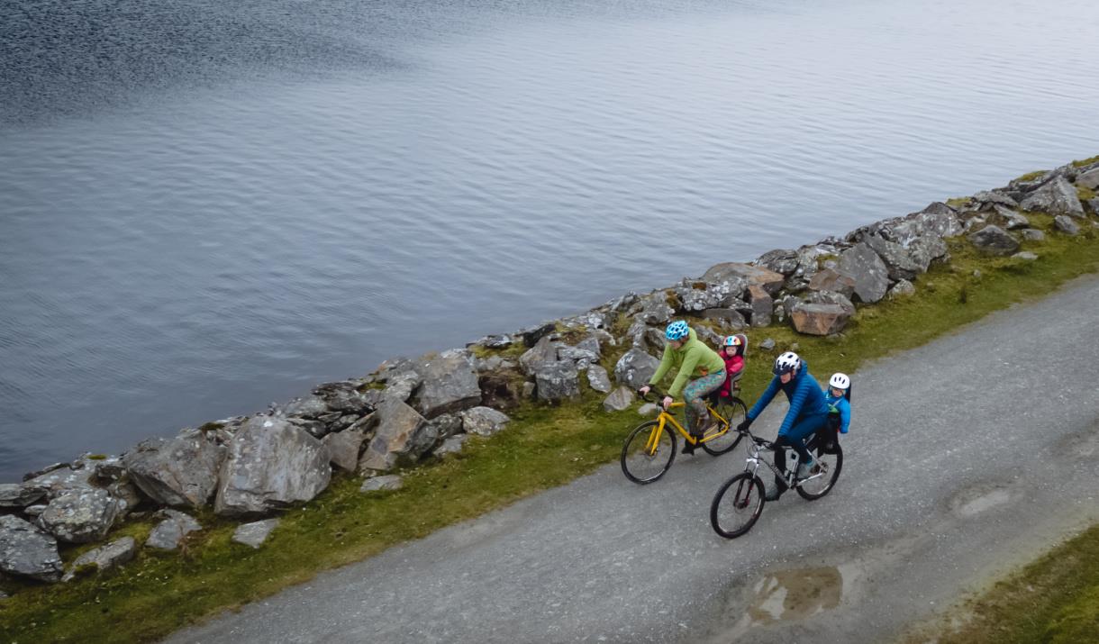 Two cyclists on lake side path