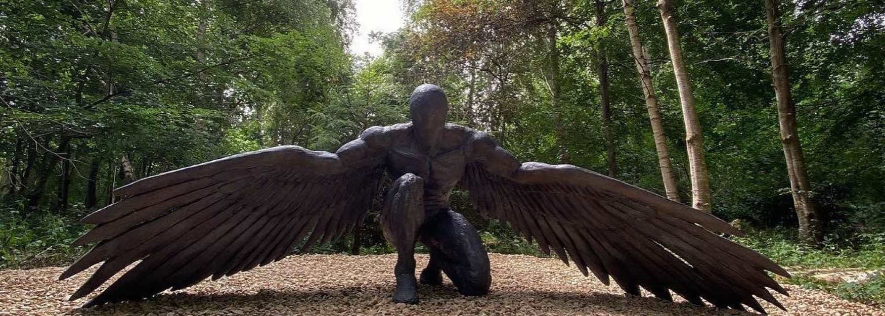 Crouching angel sculpture at Cotswold Sculpture Park