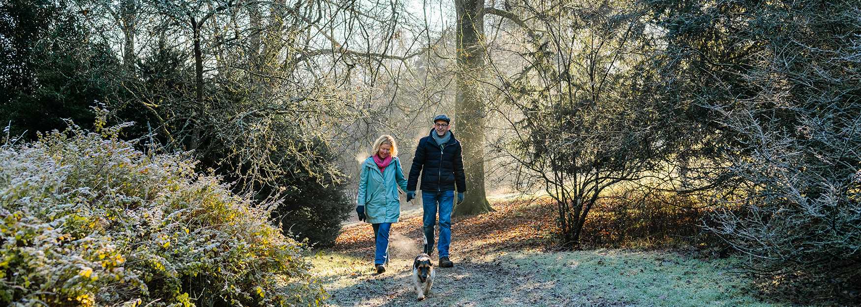 Couple walking their dog on a cold winter morning