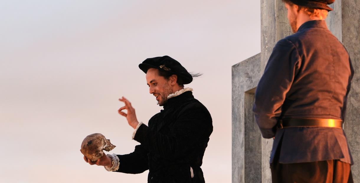 Actors in historic dress performing on an outdoor stage