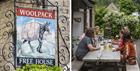 Woolpack sign and customers enjoying a drink outside the pub