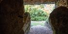 A view from inside the burial chamber of Belas Knap long barrow out through the chamber entrance