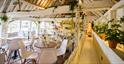 Indoor seating in the converted barn at The Cogges Kitchen in Cogges Manor Farm