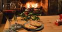A warming drink and pastry by the open fire at Heath Farm Holiday Cottages