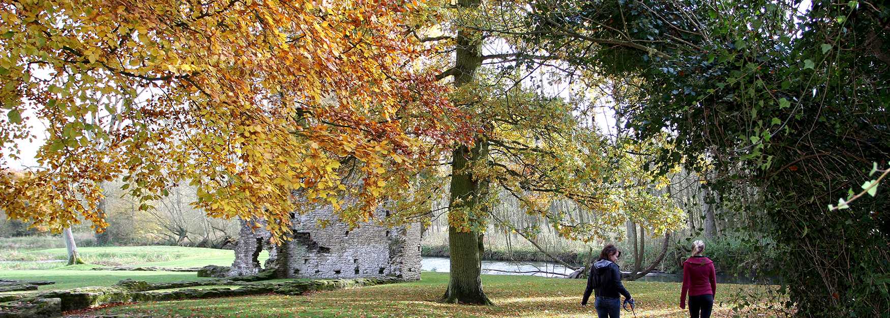 Two women walking their dog at Minster Lovell