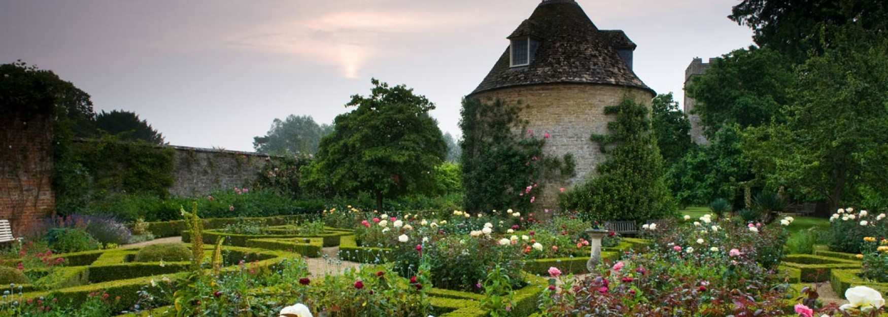 The dovecote surrounded by roses at Rousham (photo Harpur Garden Images)