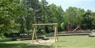 The play area with swings and a slide