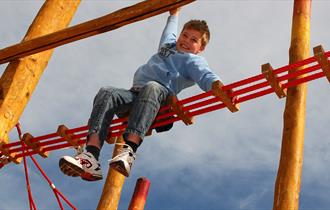 Child climbing at Kilkenny Lane Country Park