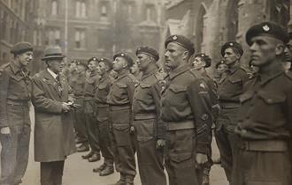 Photo of soldiers lined up for inspection in Oxford. Major John Howard and the city Mayor look on. These men served on D-Day