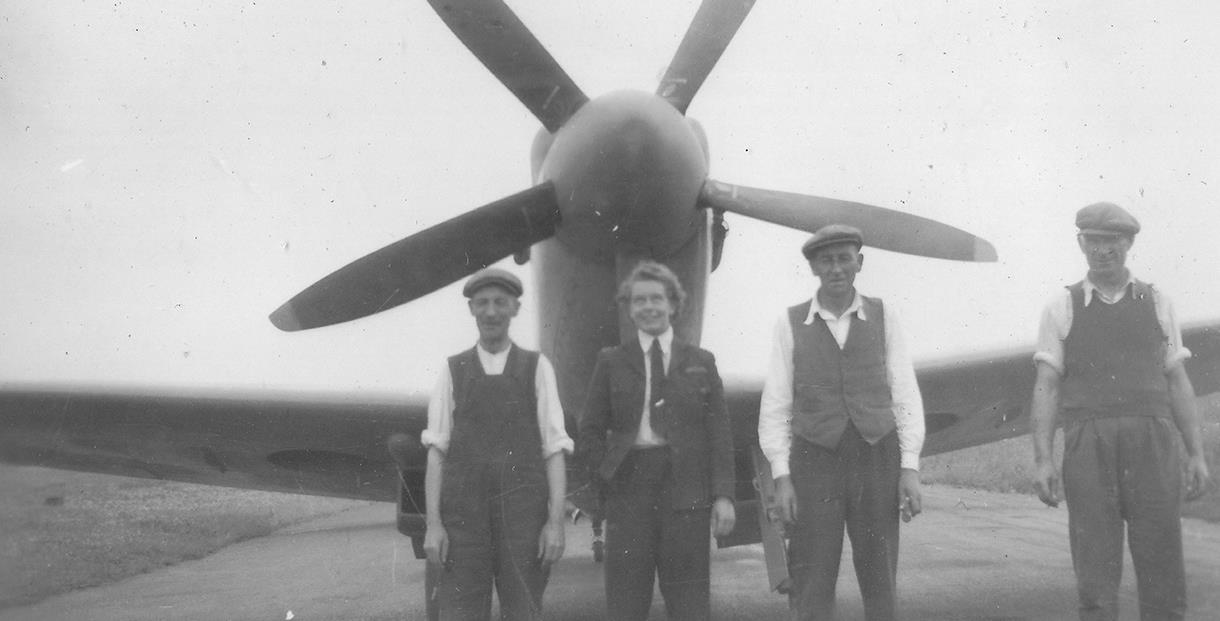 Mary Wilkins ATA stands in front of the nose of a propellor aircraft in this balck and white photograph from the Second World War (courtesy of Maidenh