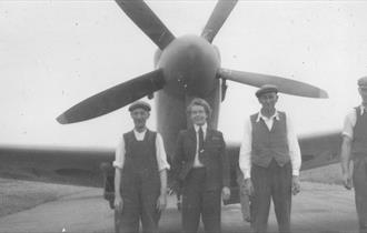 Mary Wilkins ATA stands in front of the nose of a propellor aircraft in this balck and white photograph from the Second World War (courtesy of Maidenh