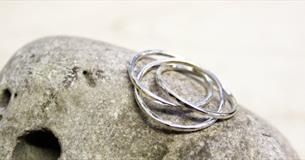 Silver Russian ring pictured on top of a stone
