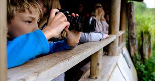 Child with camera in bird hide 