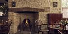 The fireplace and nearby seating at The Bell at Charlbury