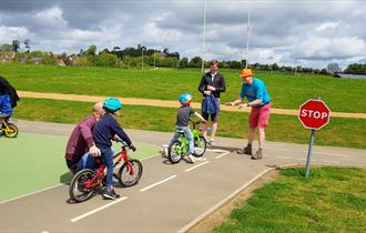 Children learning to cycle on the track