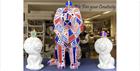 A ceramic lion designed with the union jack colours; red, white and blue.