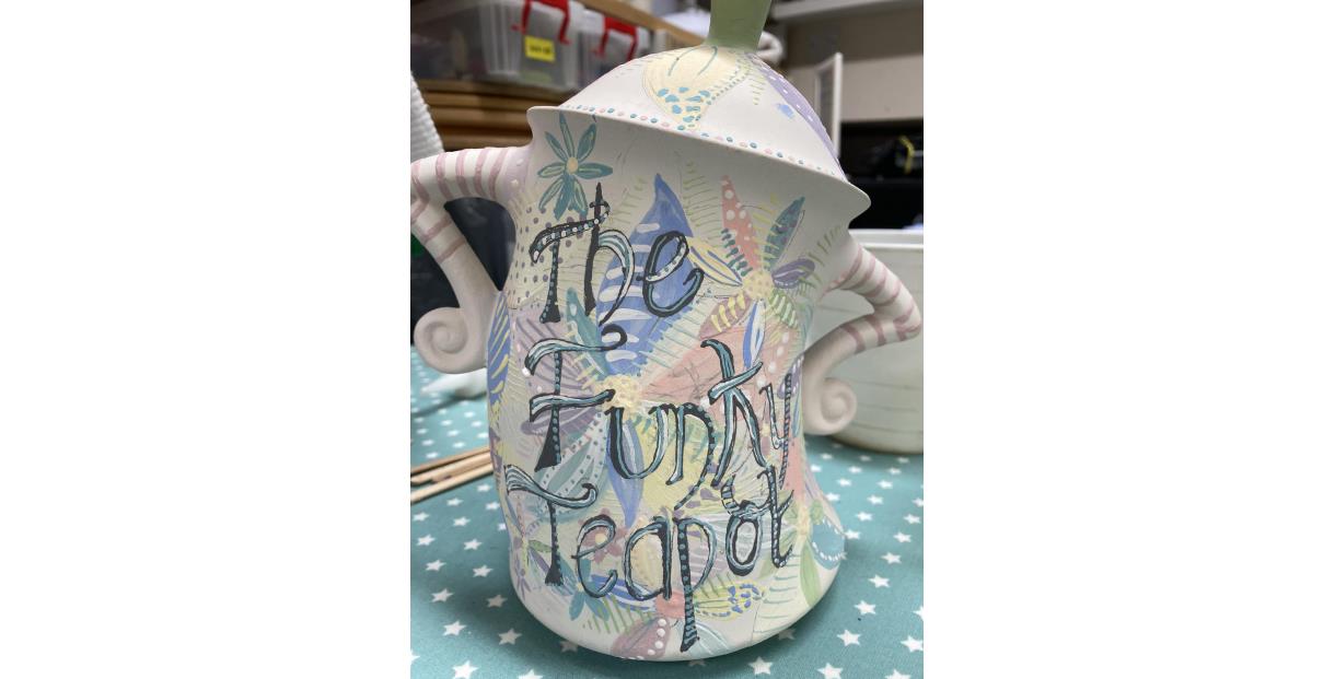 A jug with the words 'The Funky Teapot' written on it