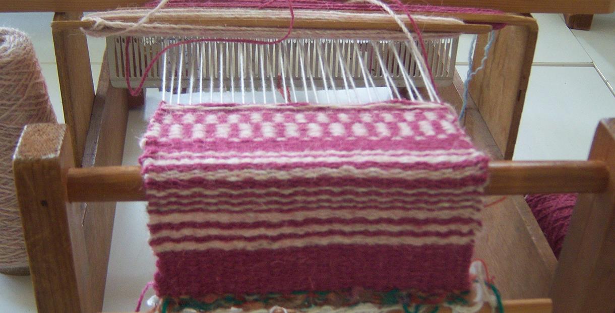 Wool being woven onto a loom
