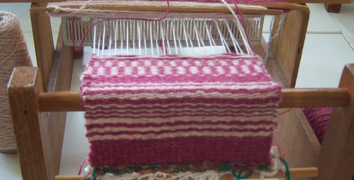 Wool being woven onto a loom