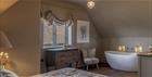 Feature bath in a bedroom at Poulton Hill