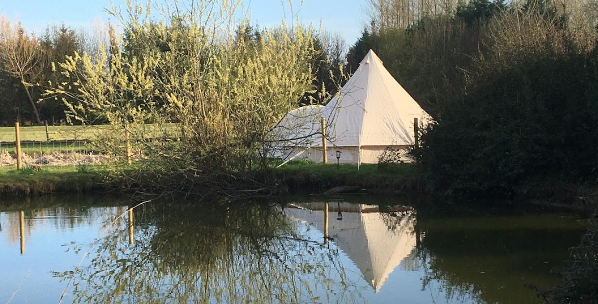 A tent pitched alongside the river
