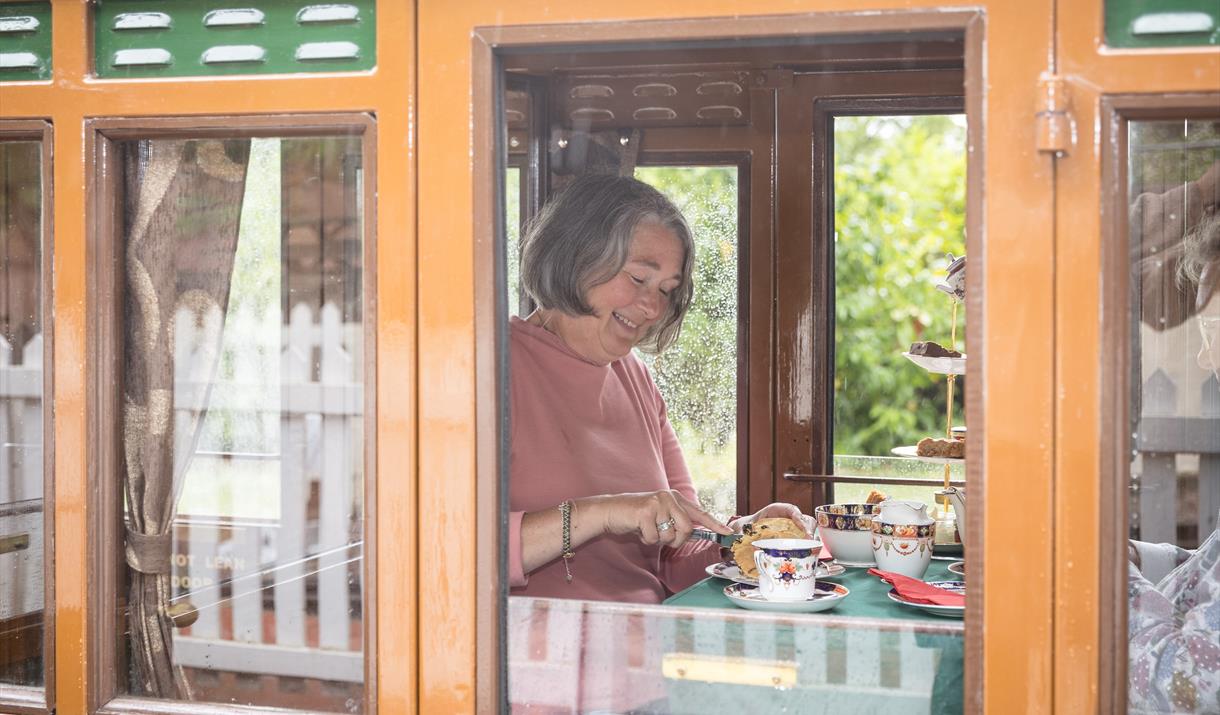 Mum eating afternoon tea on steam train