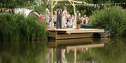 couple during wedding ceremony at the pond @ Noxon Farm