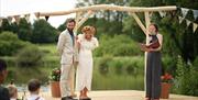 couple during wedding ceremony at the pond @ Noxon Farm