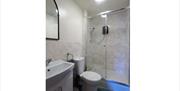 white toilet and sink, electric shower