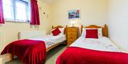 Cowshed Cottage has a double bedroom and twin bedroom, both en-suite.