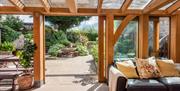 mill end mitcheldean green oak timber framed garden room to hot tub