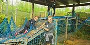 A photo showing Children in the activities Maze negotiating the nets.