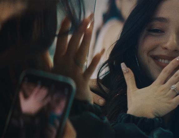 Women looking in mirror wearing ring