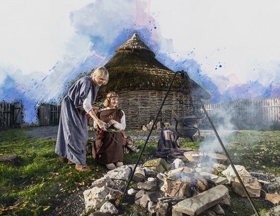 Mother and child smiling beside fire pit