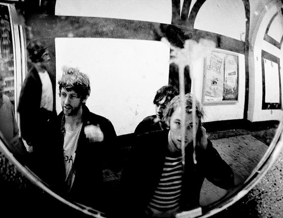 Members of the Dublin band Gilla Band gathered in front of a mirror.