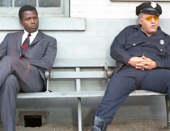 Detective and policeman sitting on a bench
