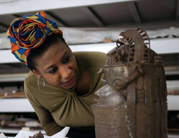 woman looking at bronze sculpture